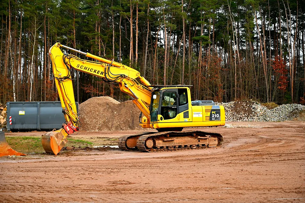 Backhoe moving reddish soil