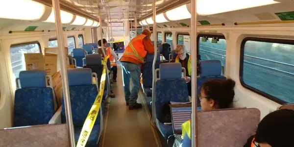 Technicians setting up gear on train to test motion
